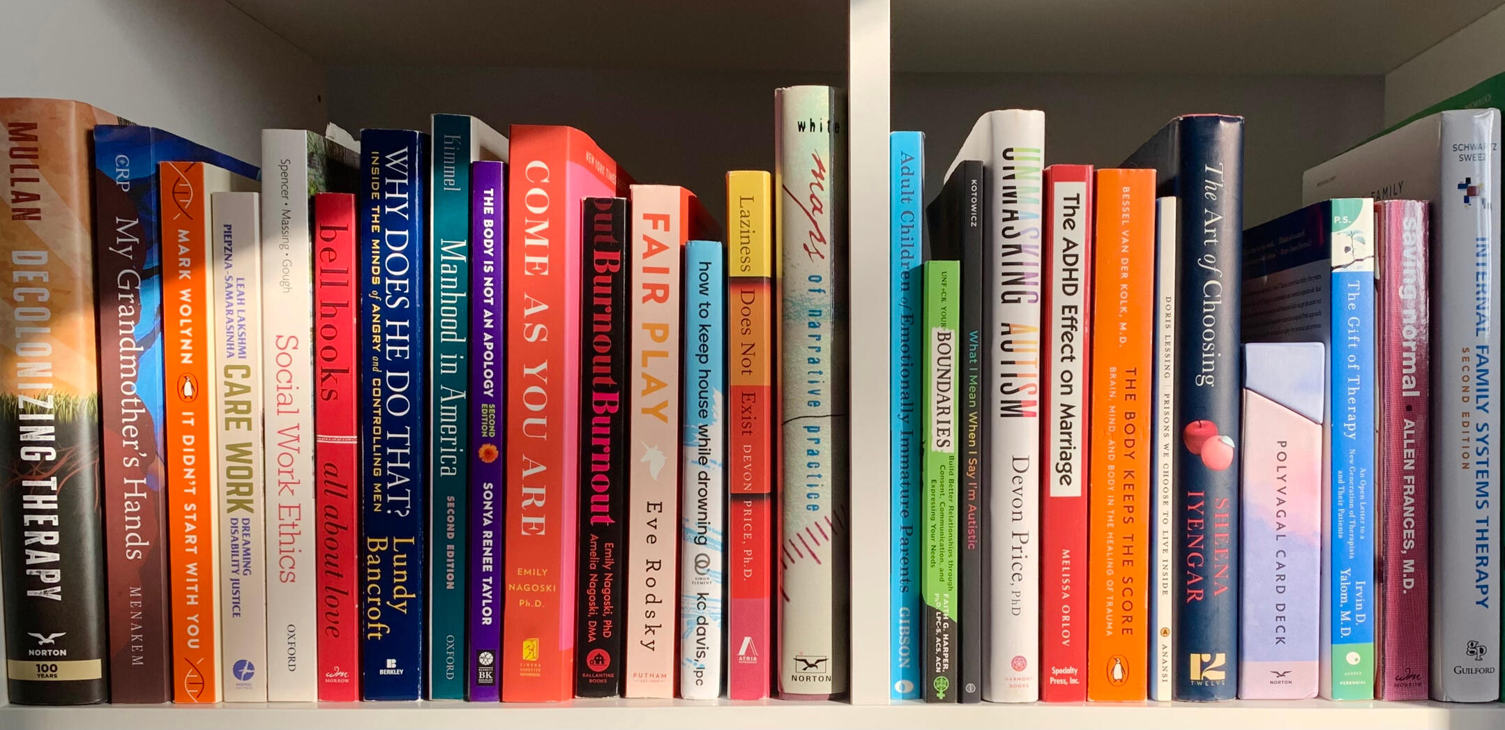 Counselling with Kelly Therapy Bookshelf Shelf of colourful books about therapy topics like trauma, anxiety, burnout, and relationships.